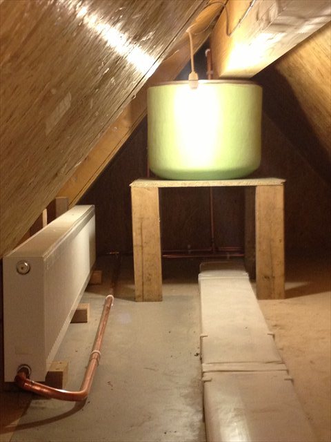 A hot water cylinder and cistern in a loft
