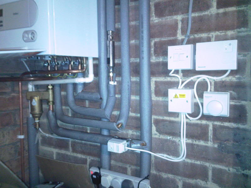 Boiler pipework and electrical connections on a wall