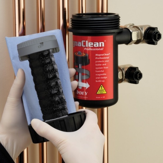 A magnetic system filter being opened for service