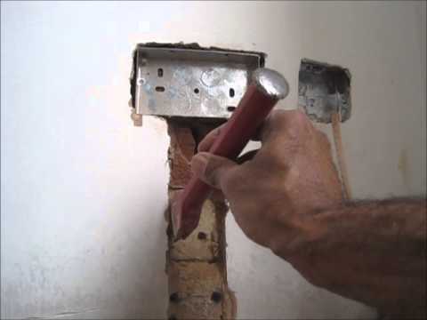 A bolster chisel and lump hammer being used to chase a wall