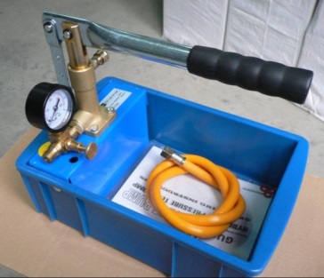 A hydraulic pressure test pump with gauge and hose