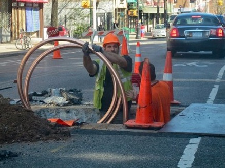 A coiled service pipe at a street excavation