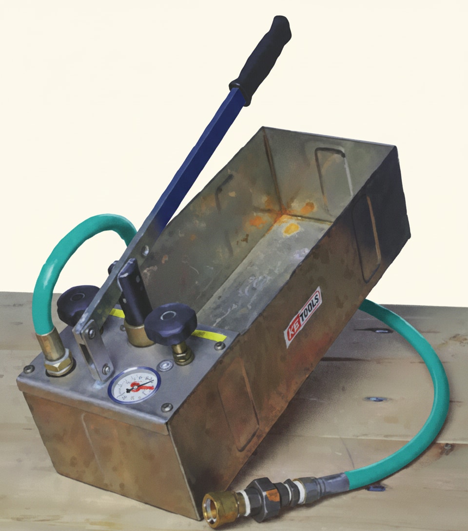 Hand-operated hydraulic test pump used to pressurise heating pipework for a soundness test