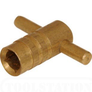 A brass T-shaped multi-purpose key with a square socket and hex socket, used on drain valves and radiator bleed points