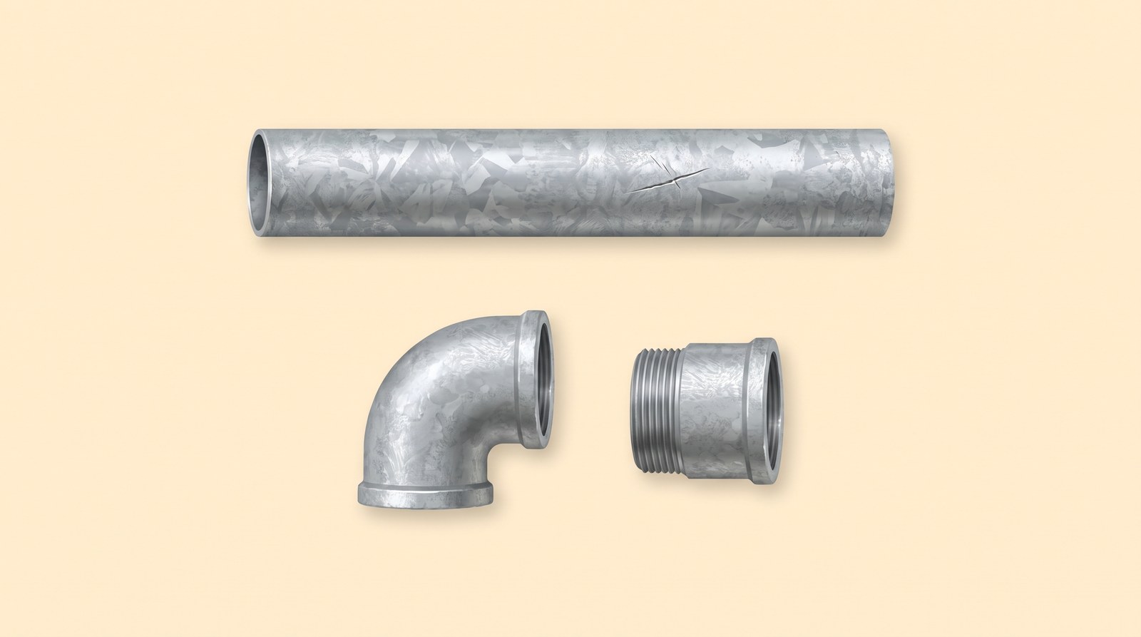 A length of galvanised steel pipe and two galvanised fittings with a dull silver spangled finish, and an unrusted scratch in the coating