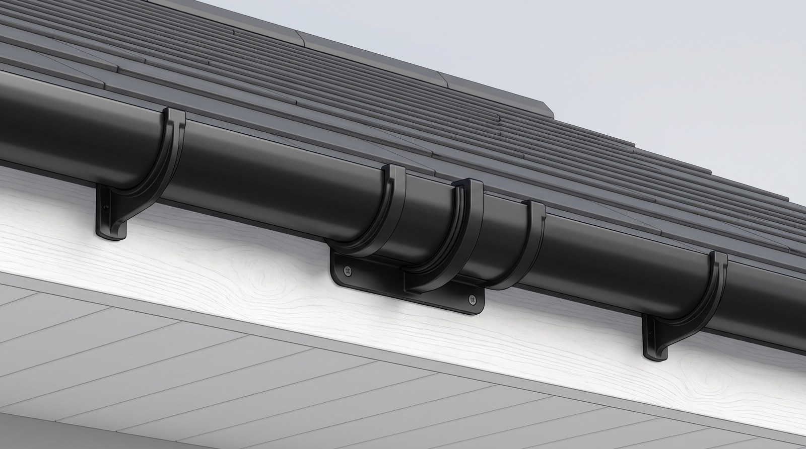 Two lengths of black half-round gutter meeting inside a single union bracket screwed to a white fascia board, with an ordinary fascia bracket either side